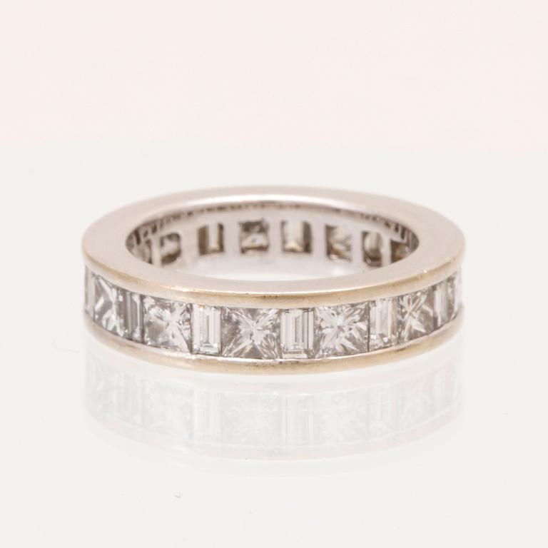 An 18K white gold eternity ring set with baguette and princess cut diamonds by Hartmann's Denmark.
