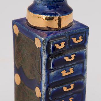 A pair of ceramic candlesticks signed Kaipiainen.