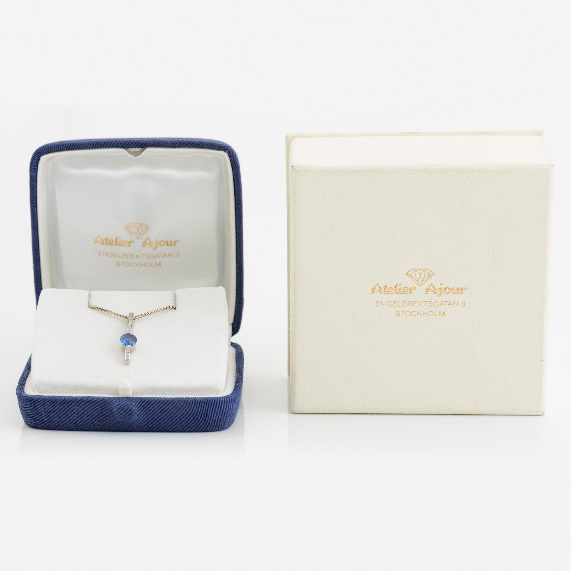 An 18K white gold necklace with a faceted sapphire.