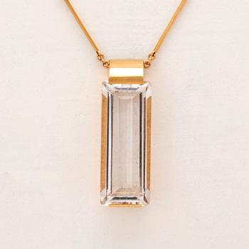 An 18K gold necklace set with a step cut rock crystal quartz by Ateljé Stigbert 1943.