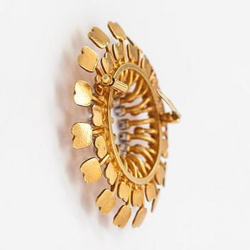 Tapio Wirkkala, Rintaneula "Aurinko", 18K kultaa ja timantteja n. 0.13 ct yht. Kultakeskus, Hämeenlinna 2000.