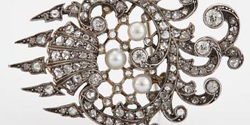 An 18K gold and silver brooch set with old- and rose-cut diamonds.