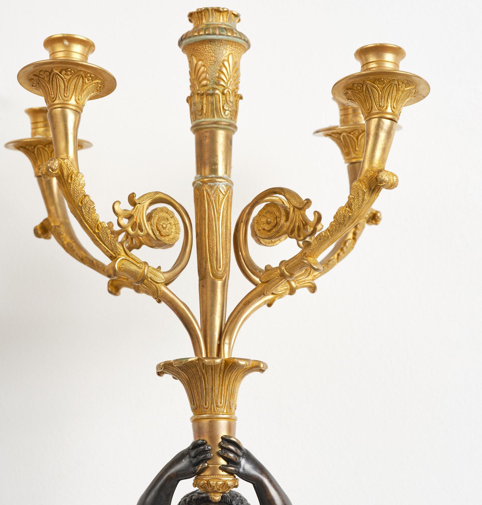 A pair of Napoleon III five-branch gilt and patinated bronze appliques.