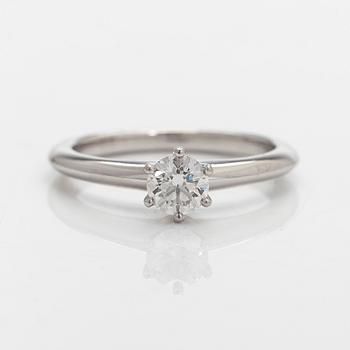 Tiffany & Co, a platinum solitaire ring with a brilliant-cut diamond.