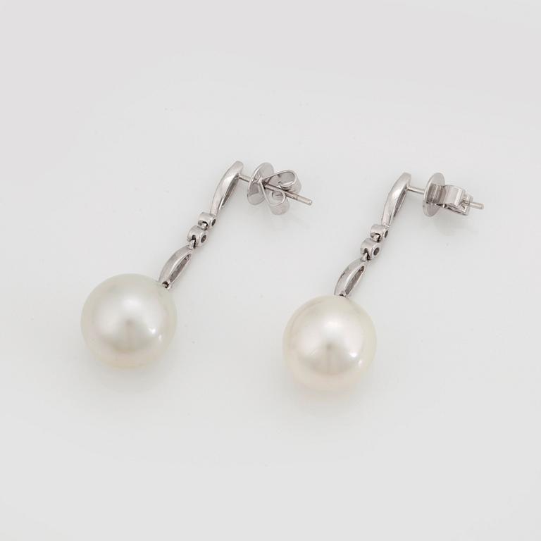 A PAIR OF EARRINGS set with cultured South Sea pearls and round brilliant-cut diamonds.