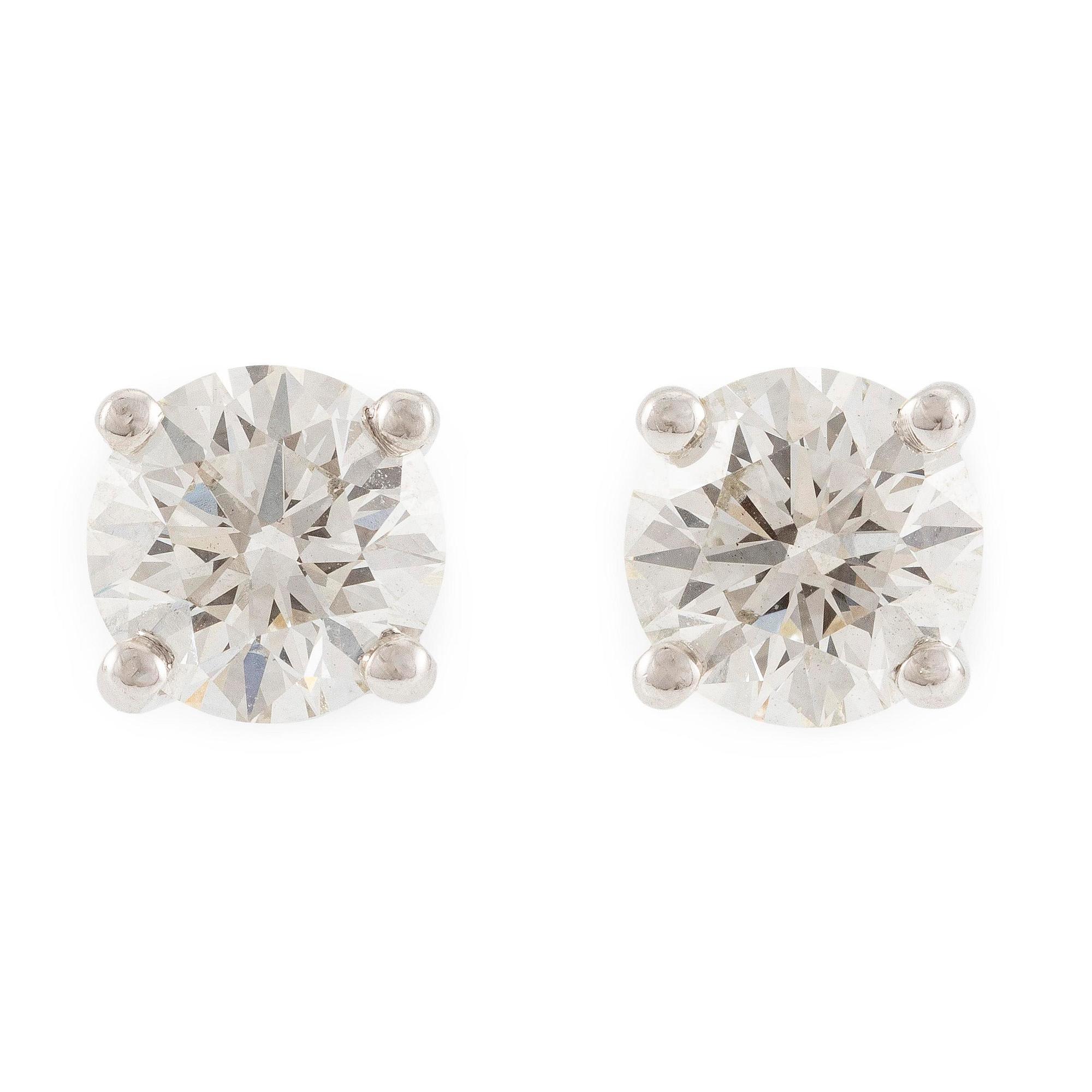 A pair of earrings in 18K white gold set with two round brilliant-cut diamonds, likely Tiffany & Co.