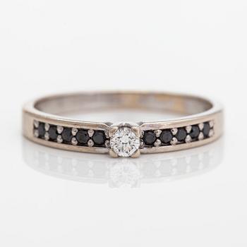 A 14K gold ring, with a brilliant-cut diamond approximately 0.07 ct and black diamonds.