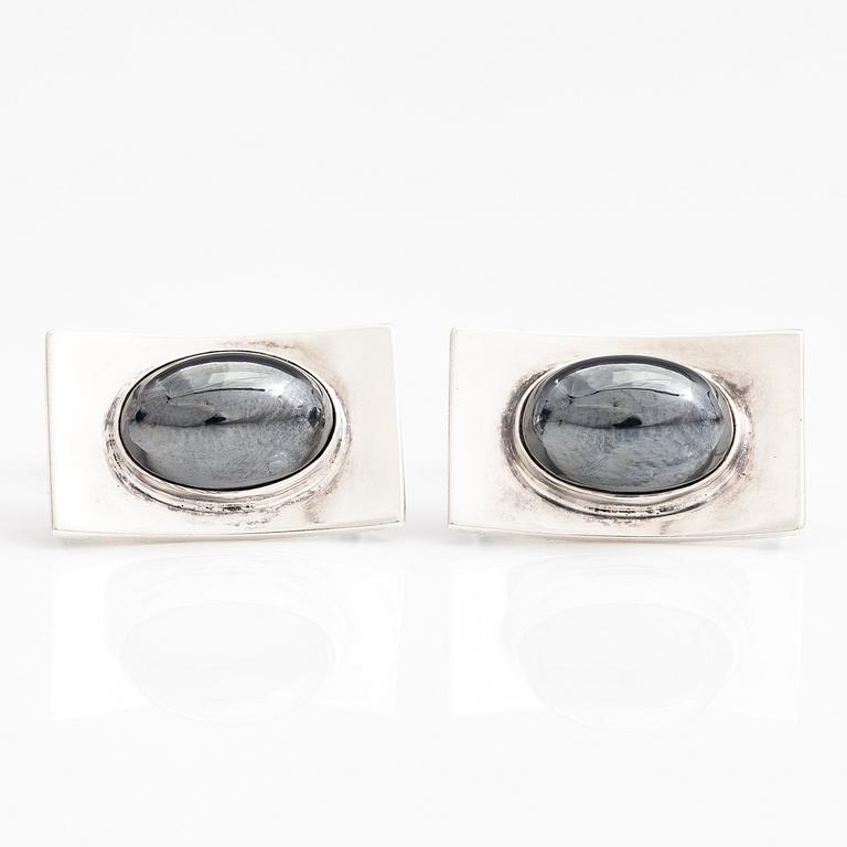 A set of three pairs of silver cufflinks with hematite, tigers eye and granite. Turun Hopea and Osvald Mättö.