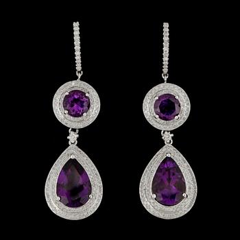 34. A pair of amethyst and brilliant-cut diamond earrings.