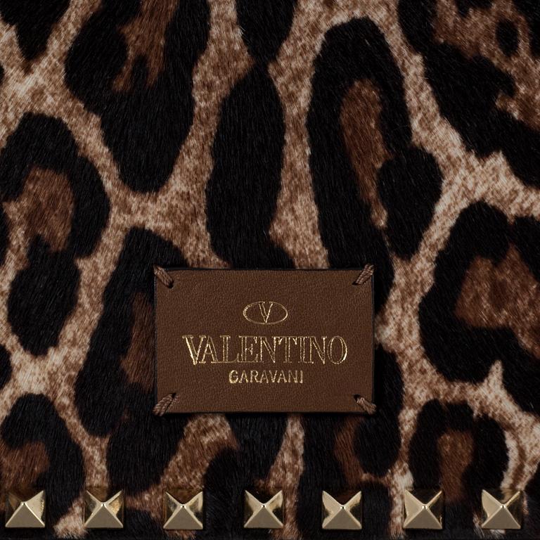 A ponyhair clutch with studs by Valentino.