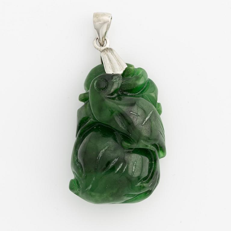 Pendant with carved green stone.