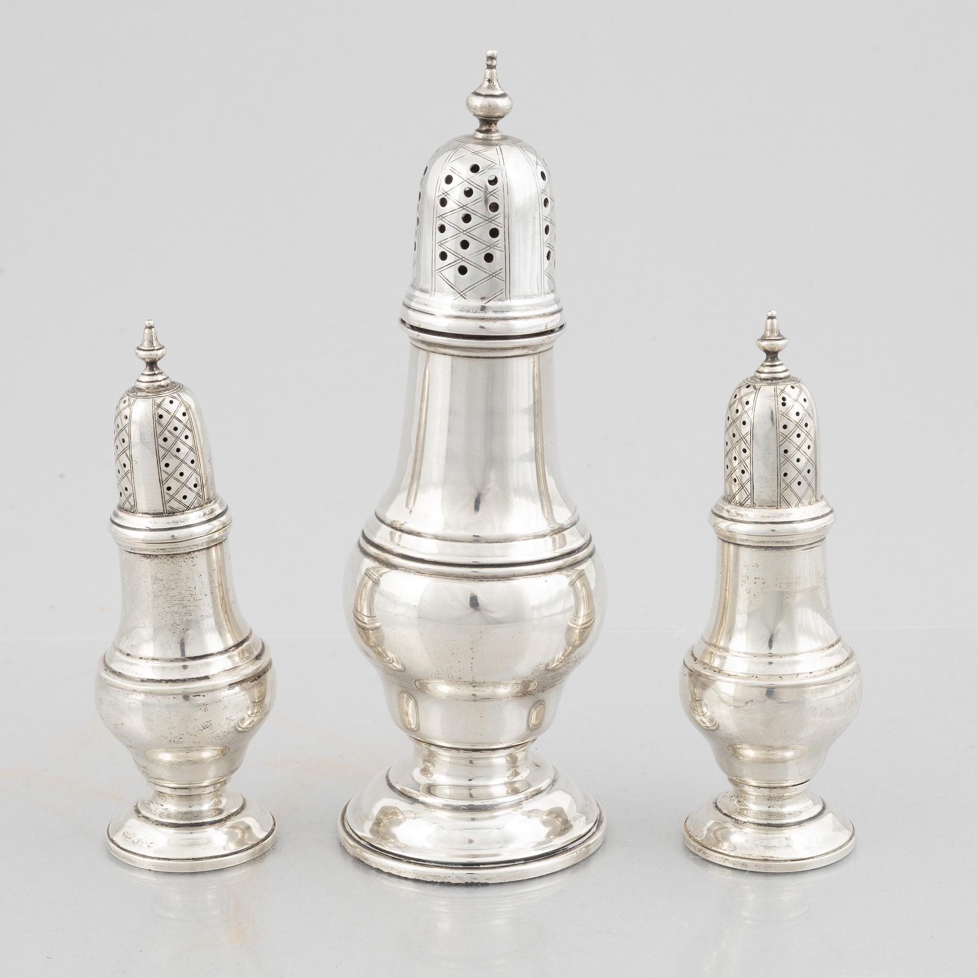 Three sterling silver shakers, 20th Century.