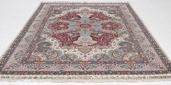 A Tabriz carpet, 210 x 195 cm. signed.
