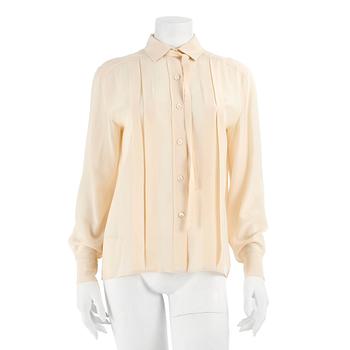 CÉLINE, a créme colored silk blouse.