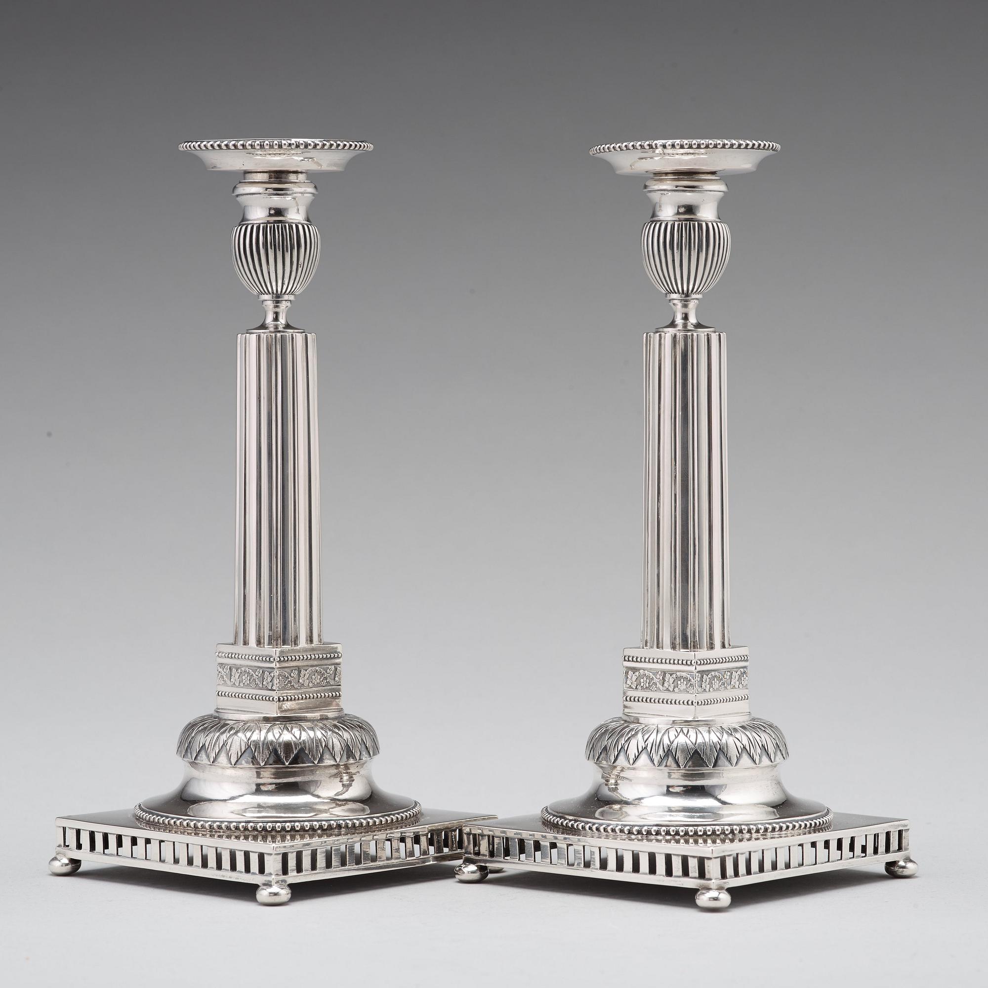 A pair of Swedish 18th century silver candlesticks, Stephan Westerstråhle, Stockholm 1793, one nozzle J E Torsk 1895.
