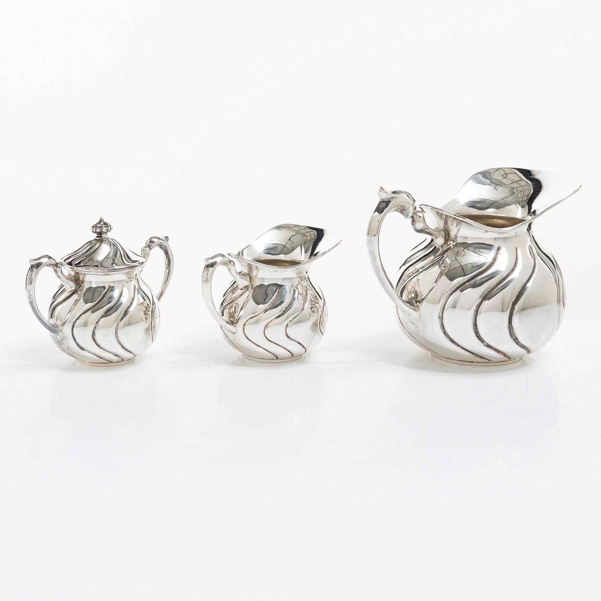 A sterling silver jug, milk jug and sugar bowl, possibly Mexico, mid20th century.