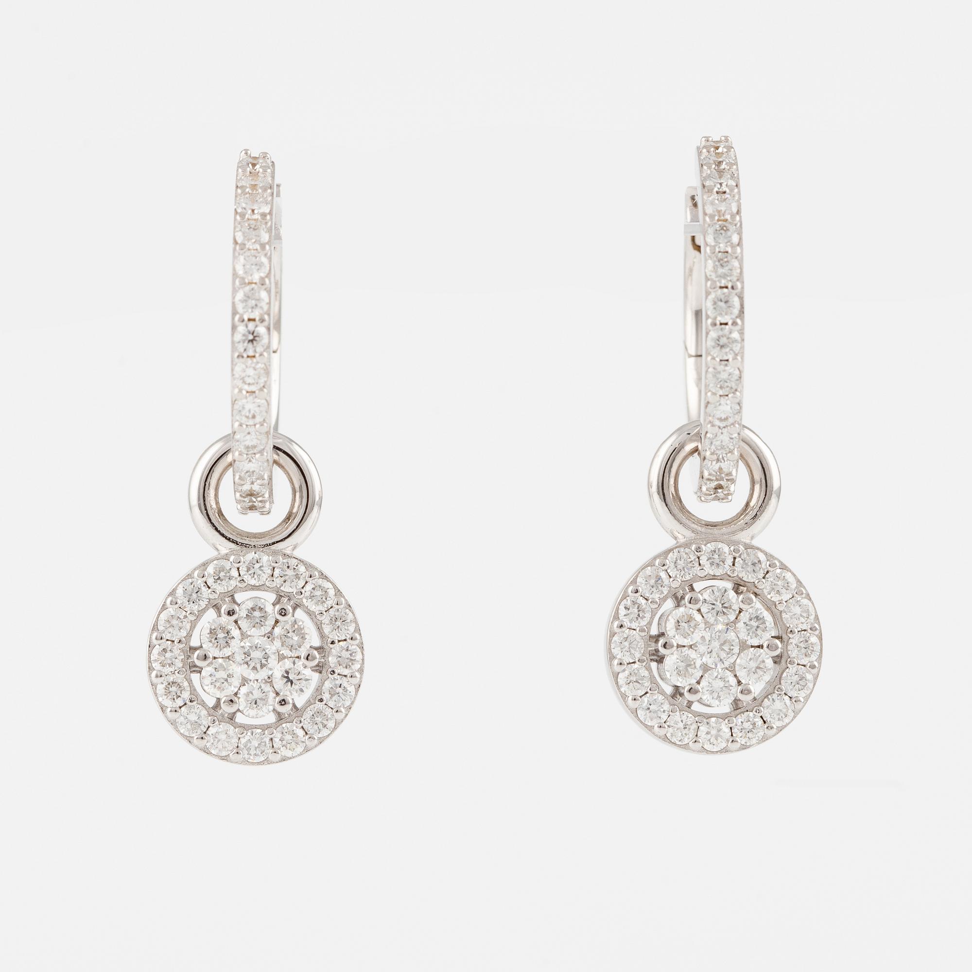 A pair of 18K gold earrings with round brilliant-cut diamonds.