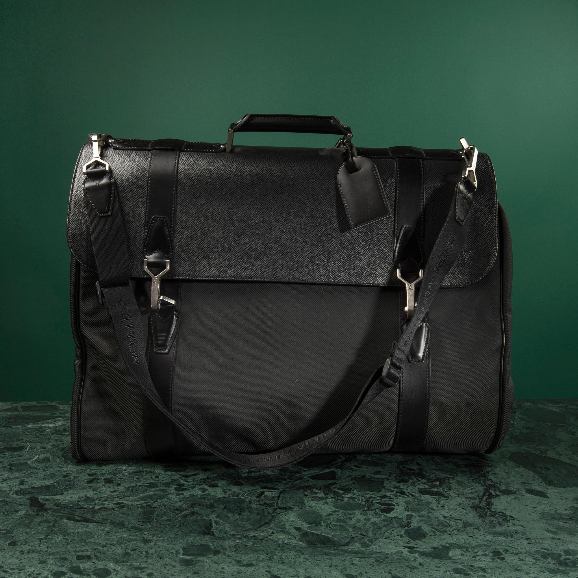 A Garment bag by Louis Vuitton.