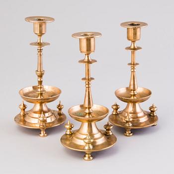 Three Russian brass candlesticks from the end of the 19th and the early 20th Century.