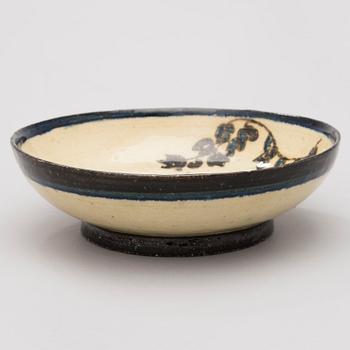 A ceramic bowl, signed GT.