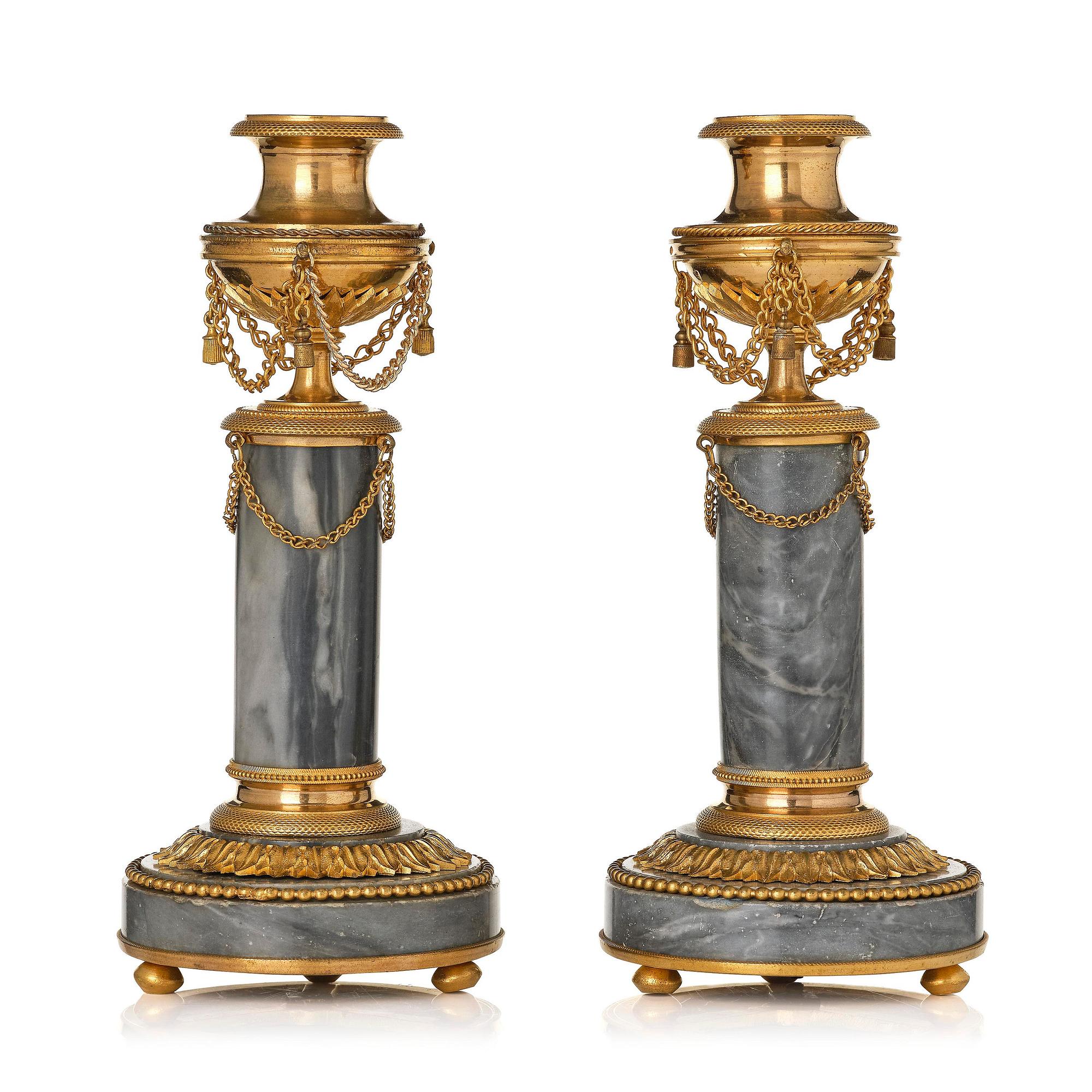 A pair of Louis XVI ormolu and Bleu turquin candlesticks.