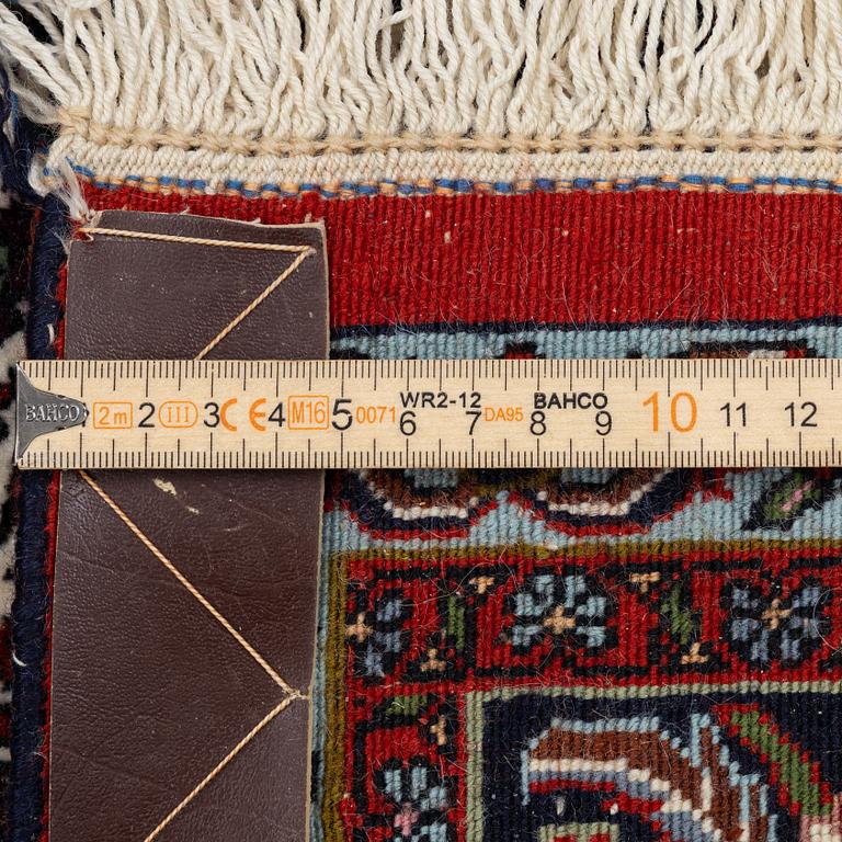 An Oriental rug, approx. 213 x 201 cm.