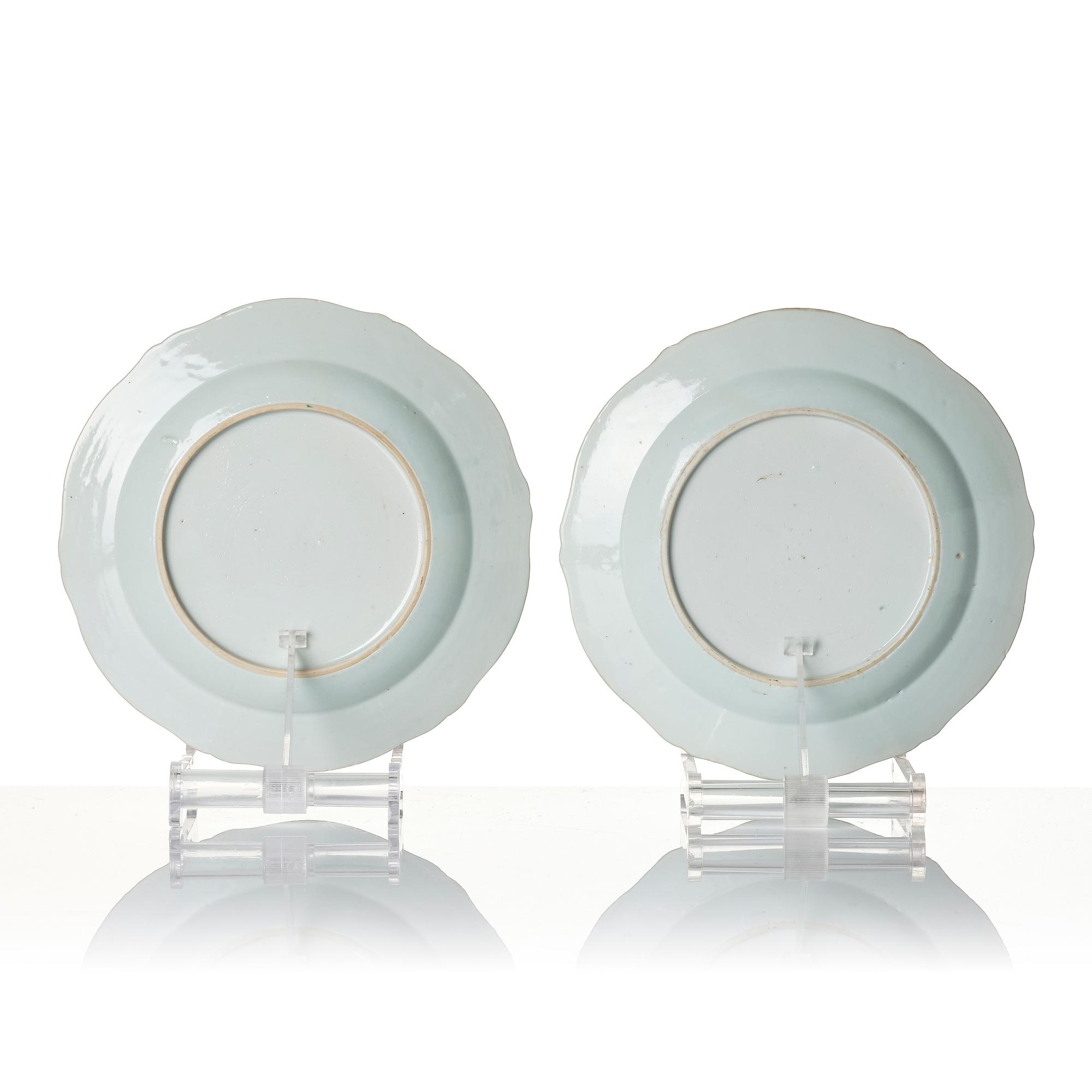 A pair of Chinese famille rose porcelain 'double peacock' plates, Qing dynasty, Qianlong (1736-95).