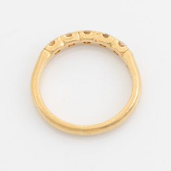An Engelbert ring in 18K gold set with round brilliant-cut diamonds.