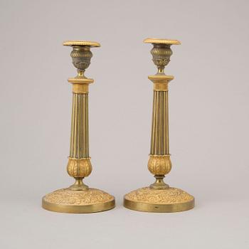 A pair of early 19th century ormolu candlesticks.