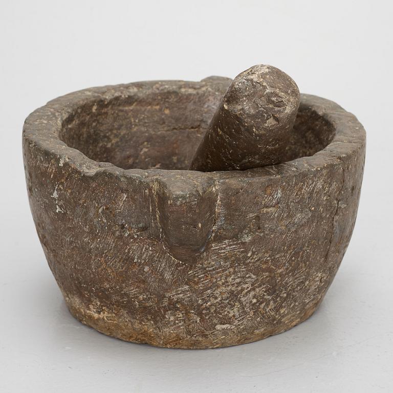 A llimestone mortar and pestle, 18th/19th Century.