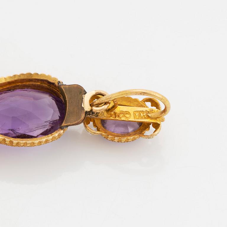 An 18K gold 19th century cross pendant and a brooch set with faceted amethysts and pearls.