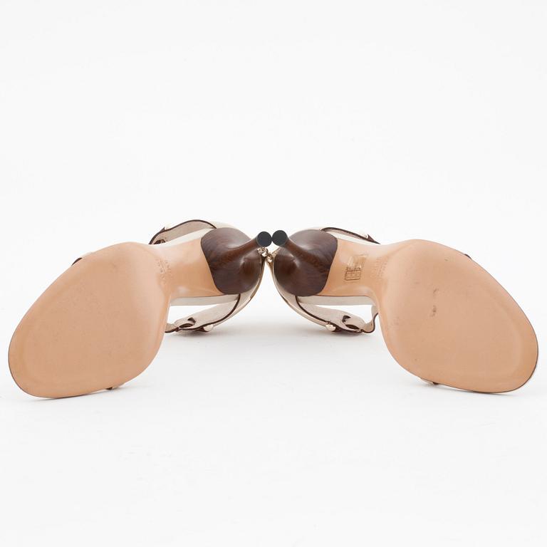 GUCCI, a pair of beige leather sandals.