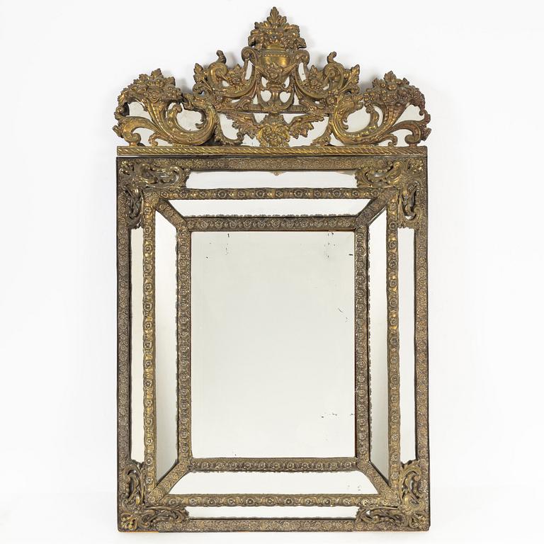 A Baroque style repoussé mirror, circa 1900.