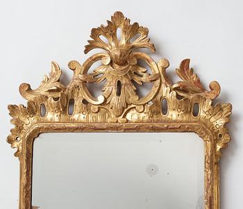 A pair of Rococo 18th century two-light girandole mirrors.