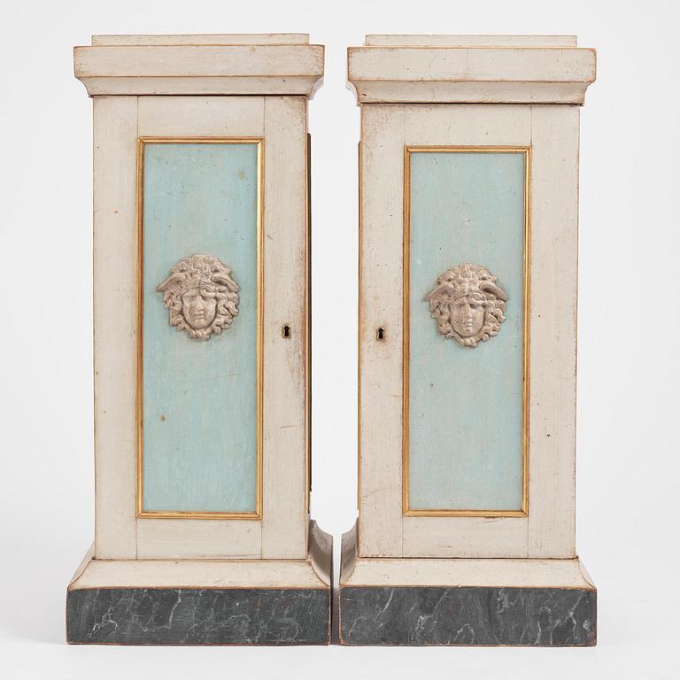 A pair of late Gustavian-style column-shaped cabinets, Stoockholm, early 19th century and later.