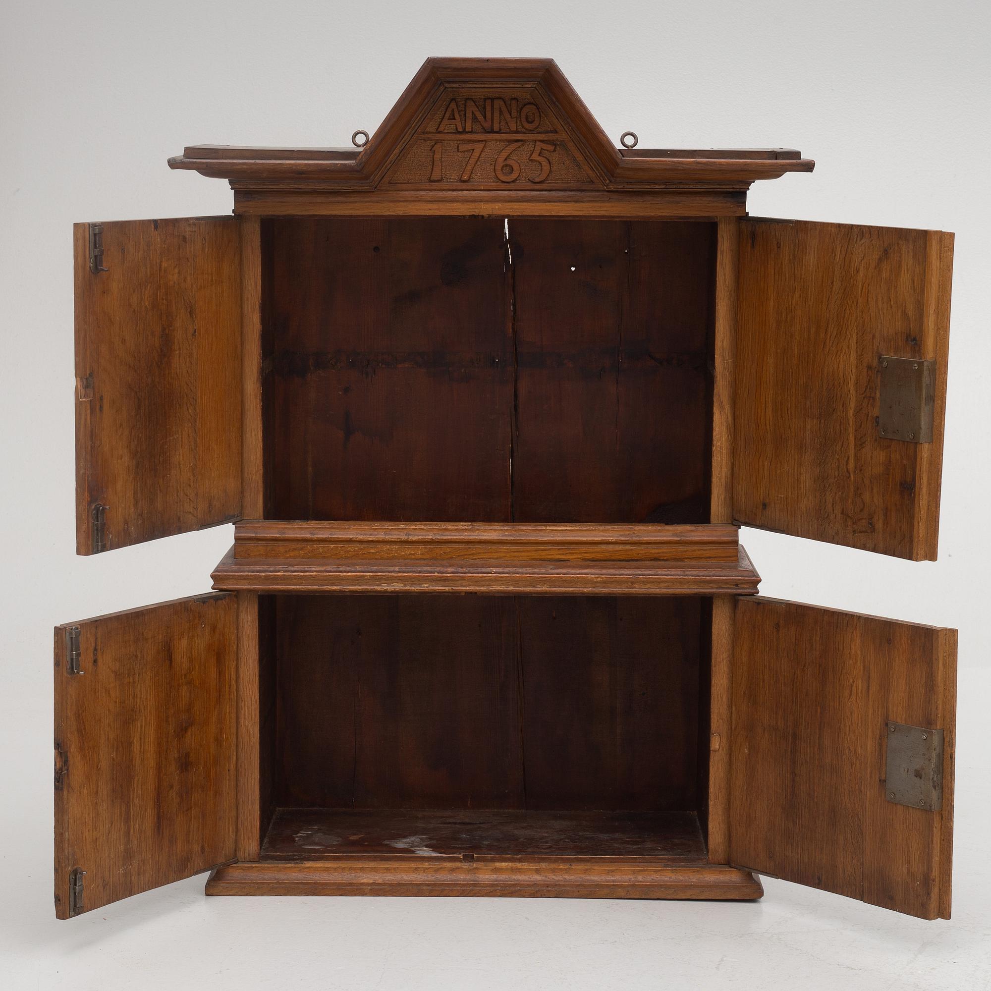 A wall cabinet, dated 1765.