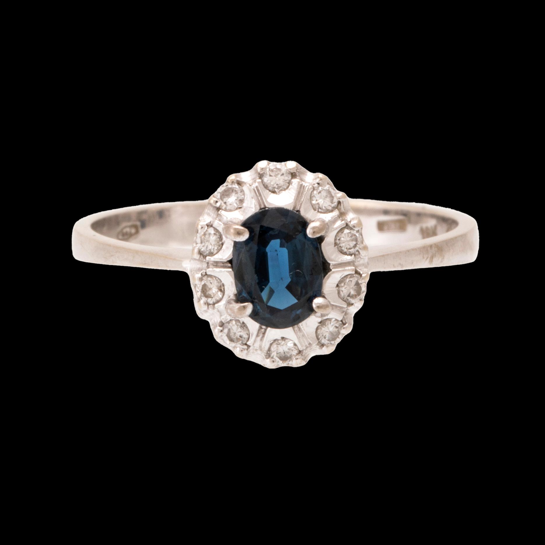 An 18K white gold carmosé ring set with an oval faceted sapphire and round brilliant-cut diamonds, Alessandria Italy.