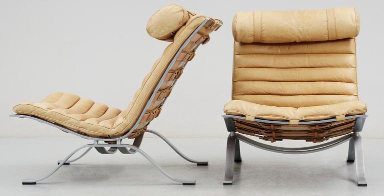 A pair of Arne Norell "Ari" brown leather and steel easy chairs by Norell.