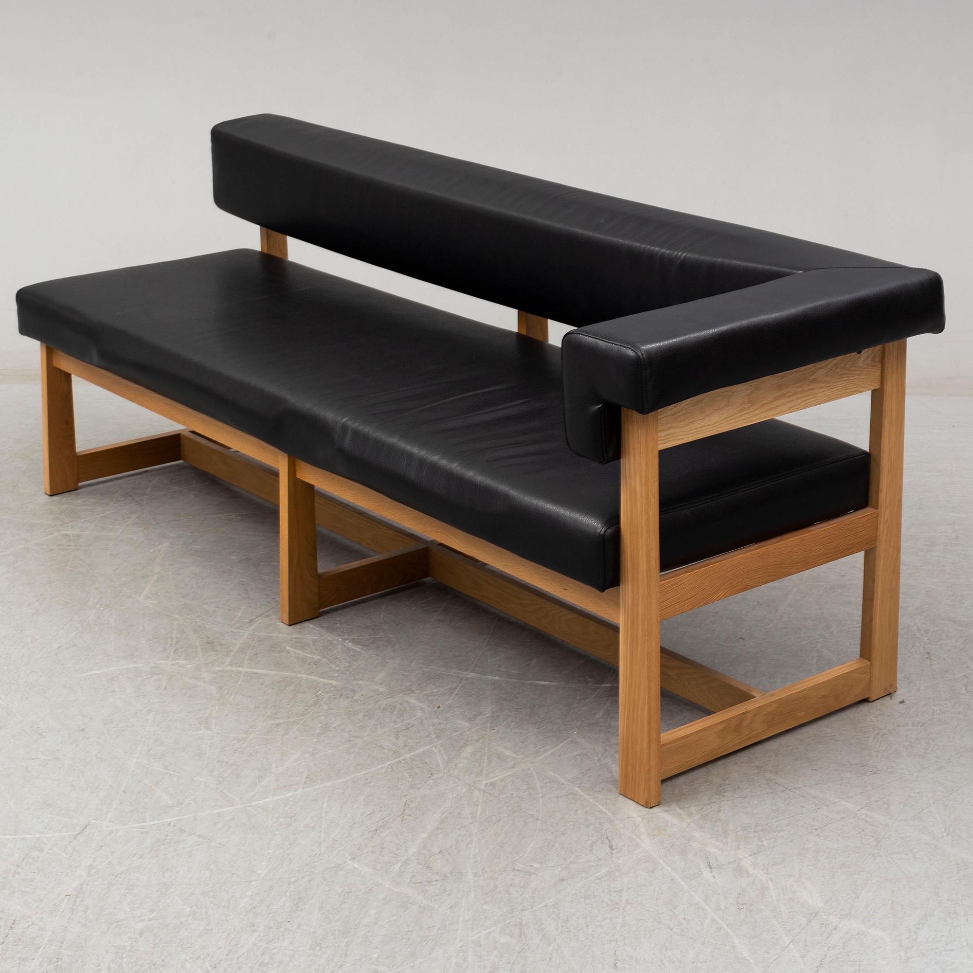 A leather covered oak sofa, 21st Century.