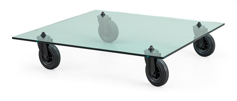 A Gae Aulenti glass and rubber wheel sofa table, 'Tavolo con Ruote', Fontana Arte, Italy.