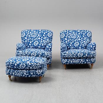 A pair of easy chairs and a stool.