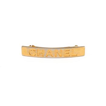 a hair barrette by Chanel.