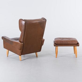 AN ARMCHAIR WITH STOOL BY SKIPPER MÖBLER, 1960/70.
