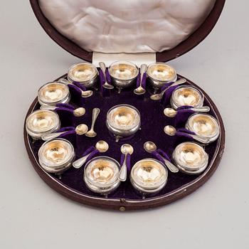 LARS LARSON & CO, 12 parcel-gilt silver and glass salt cellars with spoons, Stockholm, 1876.