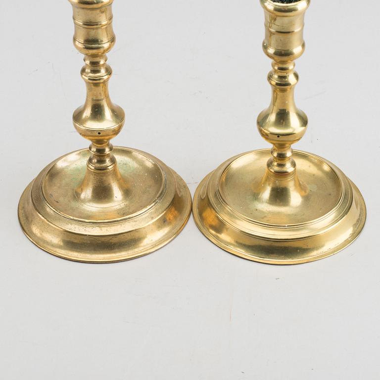 A set of two of brass candle sticks mid 18th century.