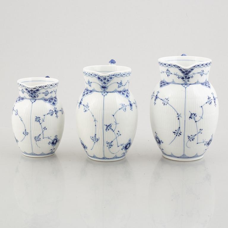 Three 'Blue Fluted Half Lace' / 'Musselmalet' porcelain jugs, Royal Copenhagen, model 562, 561, 763, 1898-1923 and 1962.