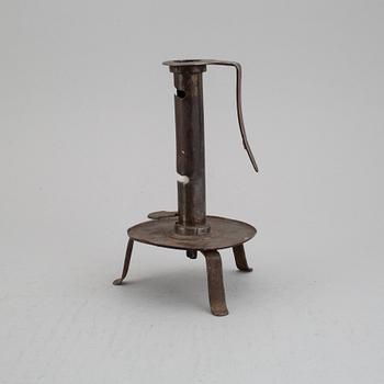 An 18th century cast iron candlestick.