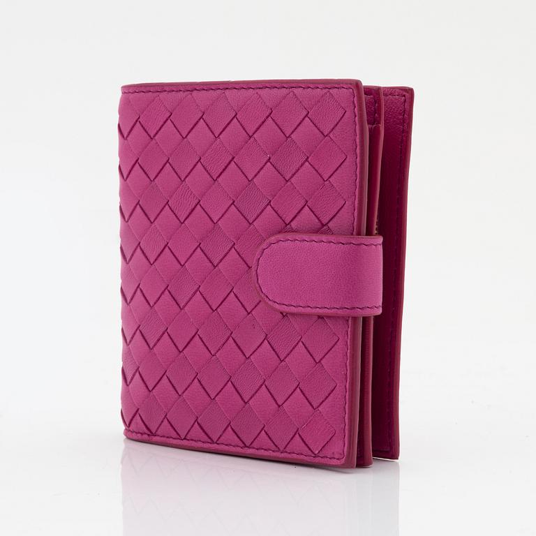 Bottega Veneta, a cerise leather wallet.