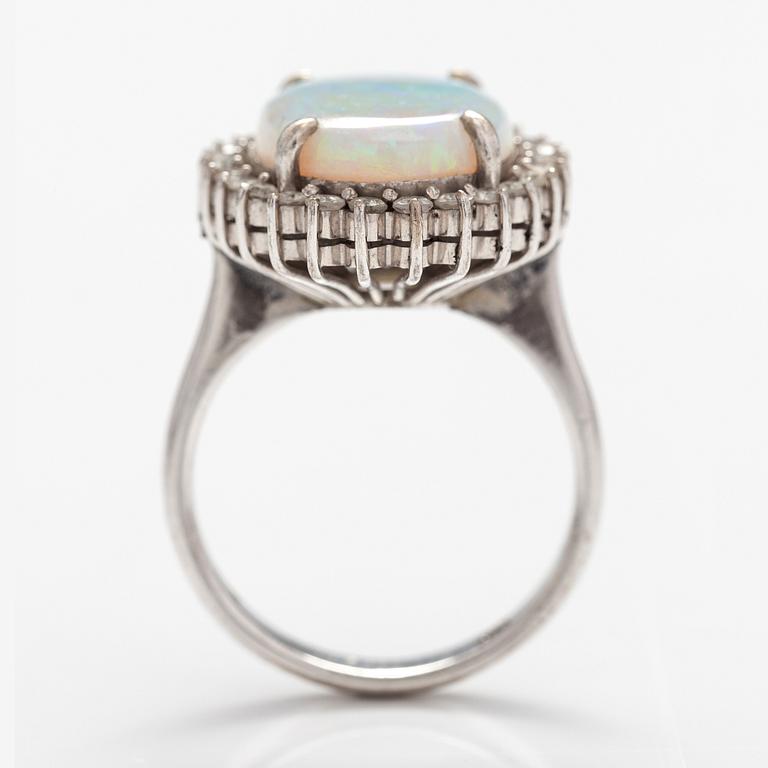 A 14K white gold ring with a probably real opal and diamonds ca. 0.65 ct in total.