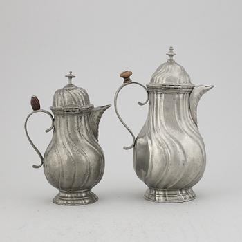 A pair of rococo style pewter coffee pots, from around year 1900.